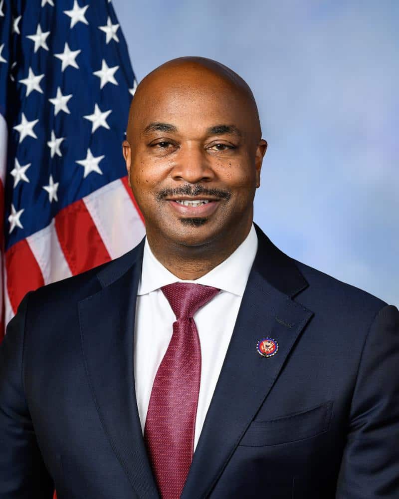 Rep. Kwanza Hall posing with American flag